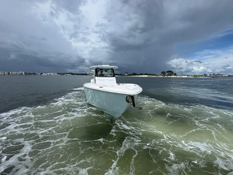 Slide: The Image of Solace 37 CS boat cruising on water under cloudy sky, 2026 model. - 18