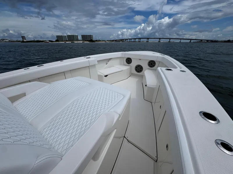 Slide: The Image of Luxurious 2026 Solace 37 CS boat interior with white seating, on a scenic waterway. - 20