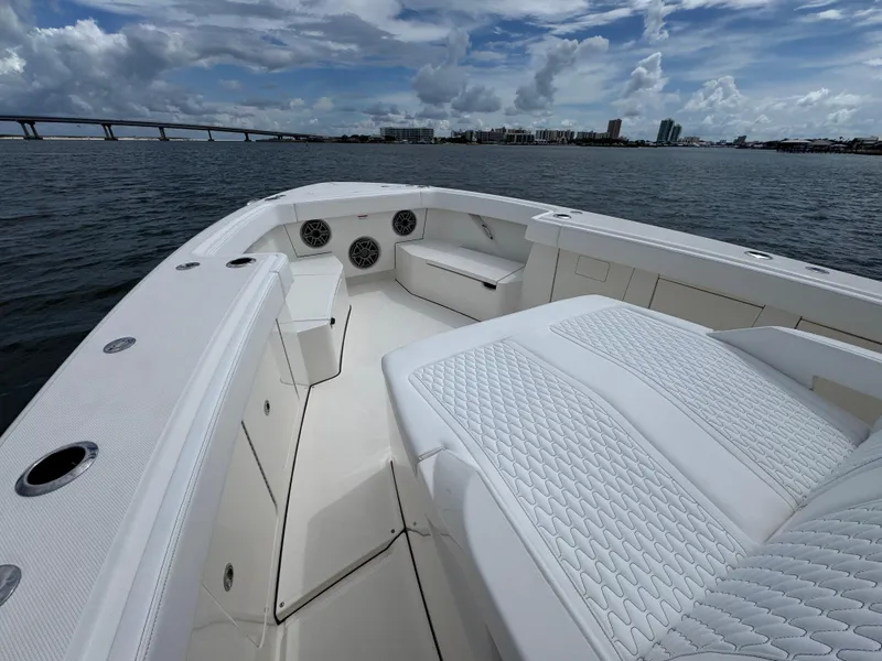 Slide: The Image of 2026 Solace 37 CS boat interior with white seating, ocean view, and bridge in background. - 22