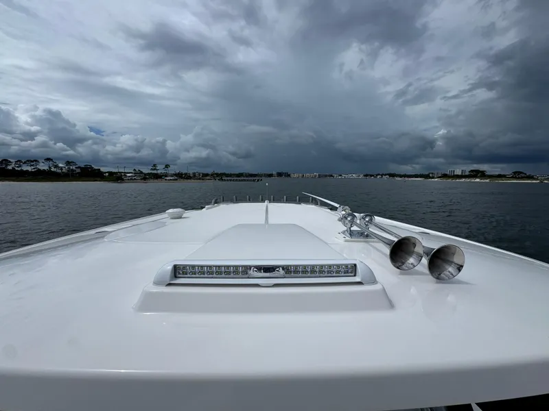 Slide: The Image of 2026 Solace 37 CS boat on water under cloudy sky, showcasing sleek design and modern features. - 26