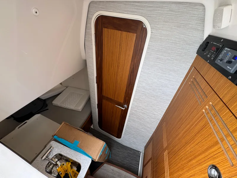 Slide: The Image of Interior of 2026 Solace 37 CS boat with wooden door and cabinetry. - 31