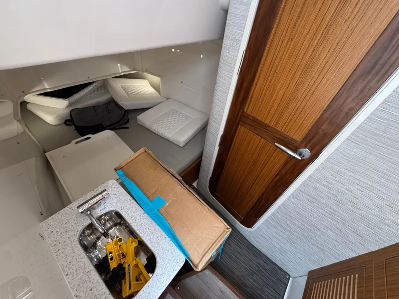Slide: The Image of Interior of 2026 Solace 37 CS boat with sink, cushions, and wooden door. - 32
