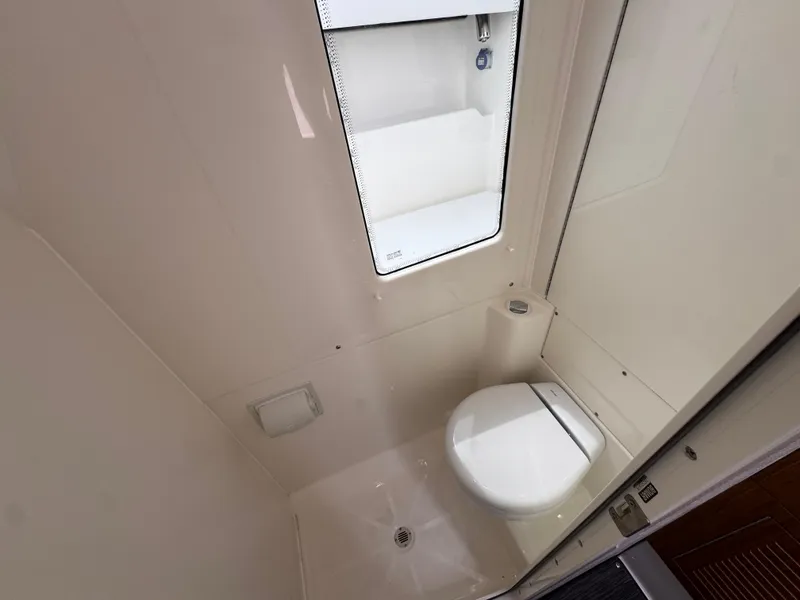 Slide: The Image of Compact bathroom in 2026 Solace 37 CS boat, featuring a modern toilet and storage. - 34