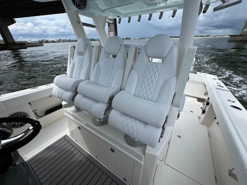 Slide: The Image of Luxury seating on 2026 Solace 37 CS boat, featuring sleek white design and ocean backdrop. - 35