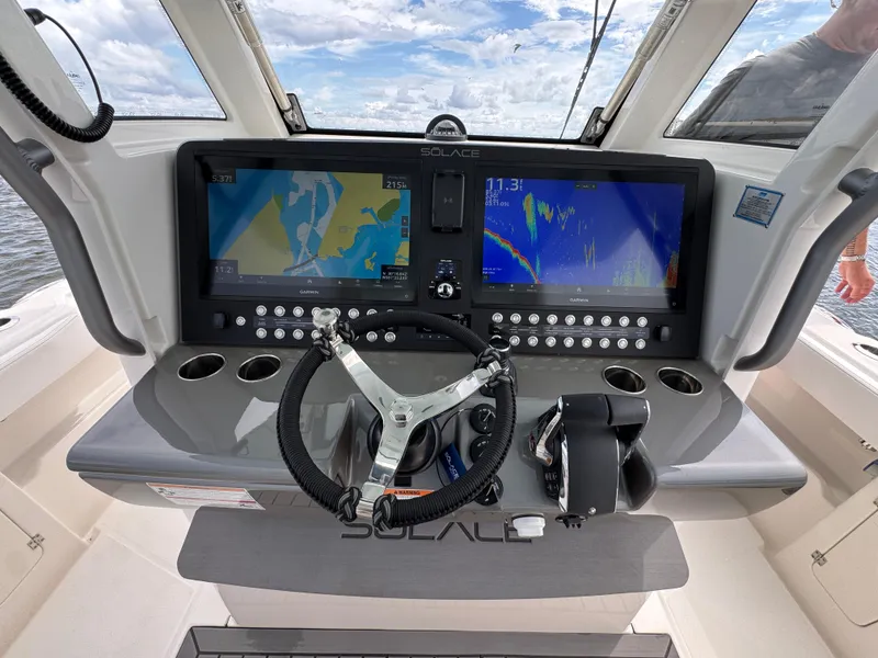 Slide: The Image of Helm of 2026 Solace 37 CS boat with advanced navigation displays and controls. - 39