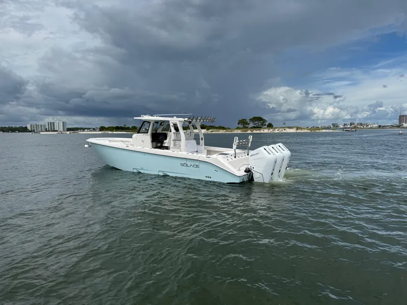 Slide: The Image of 2026 Solace 37 CS boat cruising on a calm waterway under cloudy skies. - 4