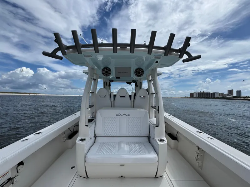 Slide: The Image of 2026 Solace 37 CS boat interior with seating, ocean view, and cloudy sky. - 43