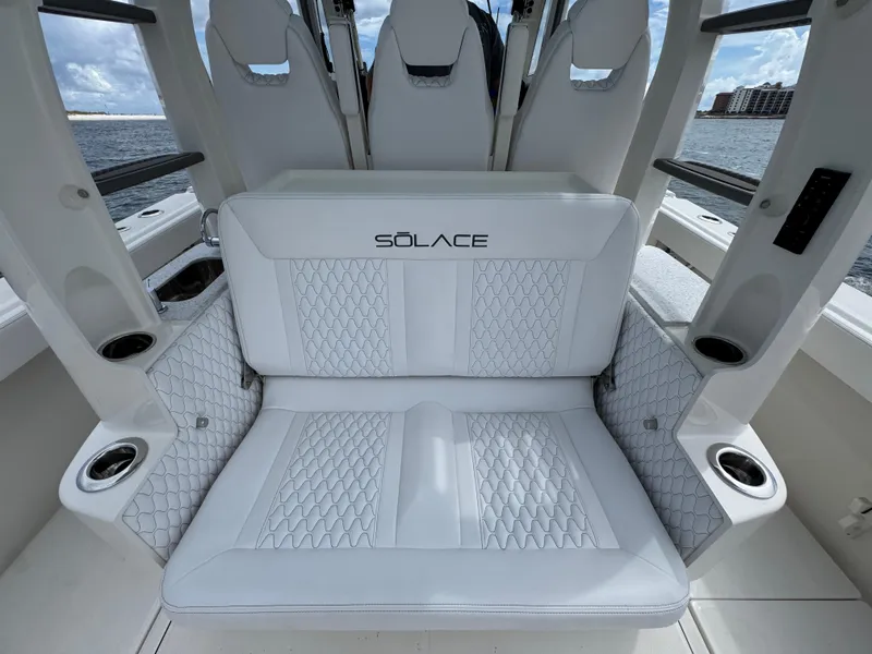 Slide: The Image of Luxury seating on 2026 Solace 37 CS boat, featuring elegant white upholstery and cup holders. - 44