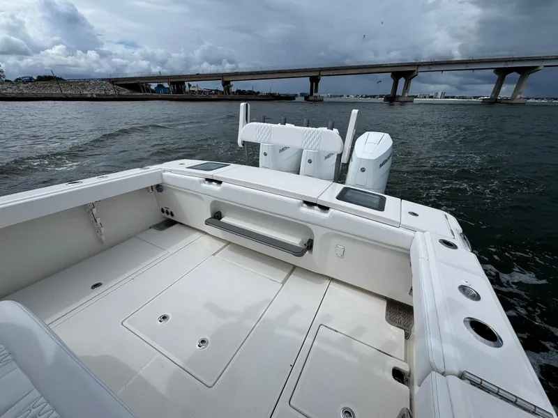 Slide: The Image of 2026 Solace 37 CS boat with dual engines on a cloudy day near a bridge. - 46