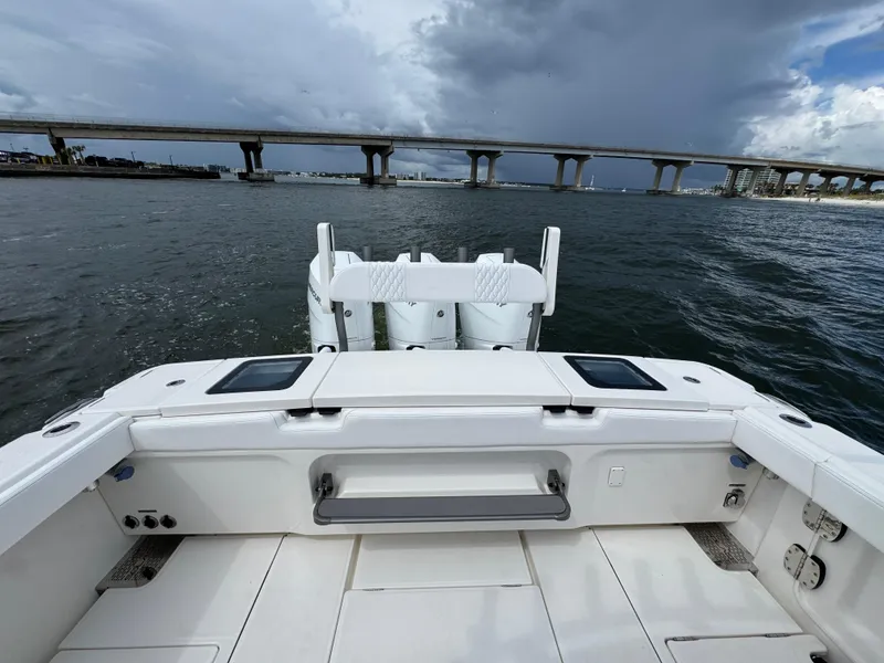 Slide: The Image of 2026 Solace 37 CS boat on water, bridge in background, cloudy sky. - 47