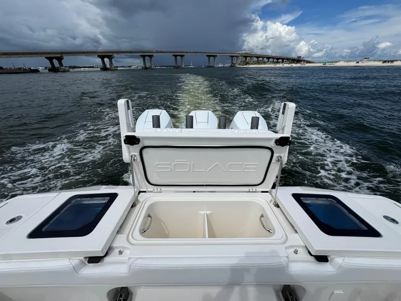Slide: The Image of 2026 Solace 37 CS boat cruising under a bridge with open storage compartment. - 48