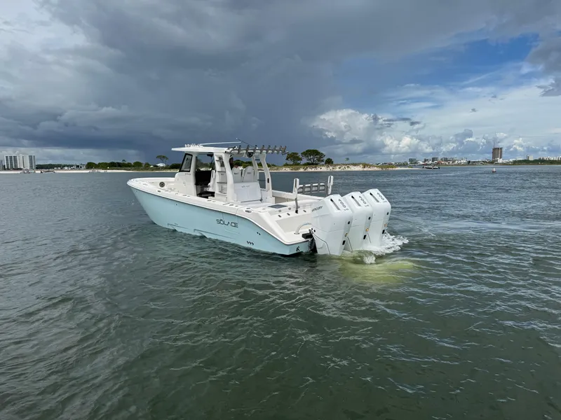 Slide: The Image of 2026 Solace 37 CS boat with triple engines on open water under cloudy sky. - 5