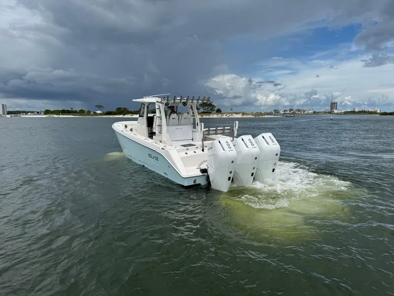 Slide: The Image of 2026 Solace 37 CS boat with triple engines cruising on a cloudy day. - 6
