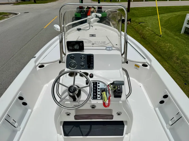 Slide: The Image of 2017 Blue Wave 2000 PureBay boat interior with steering wheel and control panel. - 11