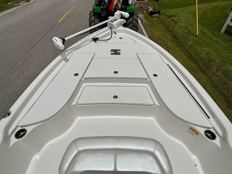 Slide: The Image of 2017 Blue Wave 2000 PureBay boat deck with trolling motor on a road. - 13