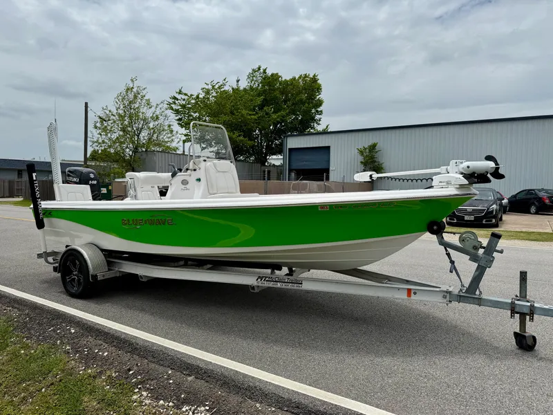 Slide: The Image of 2017 Blue Wave 2000 PureBay boat on trailer, vibrant green and white design. - 5
