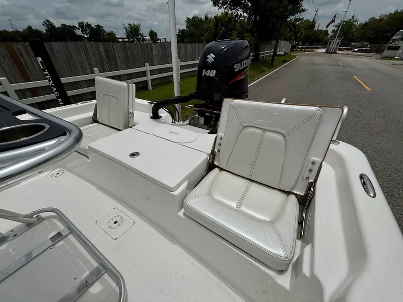 Slide: The Image of 2017 Blue Wave 2000 PureBay boat with Suzuki 140 outboard motor, white seating, and storage. - 7