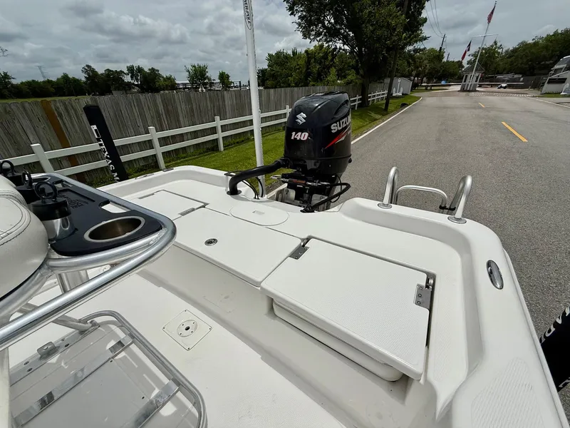 Slide: The Image of 2017 Blue Wave 2000 PureBay boat with Suzuki 140 outboard motor, parked on a street. - 8