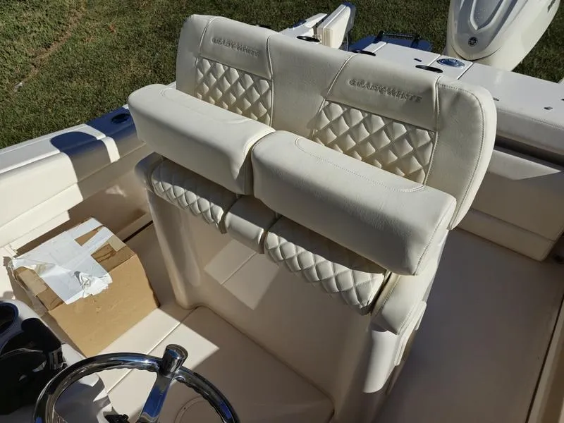Slide: The Image of 2025 Grady-White Fisherman 236 boat interior with quilted seating and steering wheel. - 12