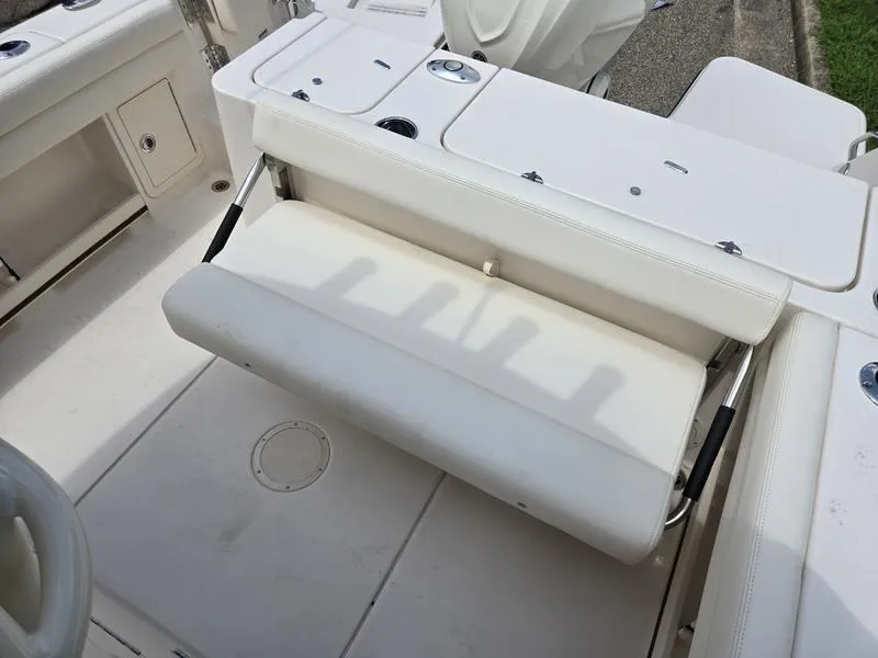 Slide: The Image of 2025 Grady-White Fisherman 236 boat interior with foldable seating and storage compartments. - 14