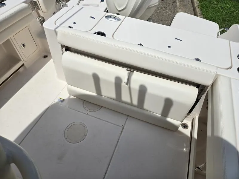 Slide: The Image of 2025 Grady-White Fisherman 236 boat interior with white seating and storage compartments. - 16