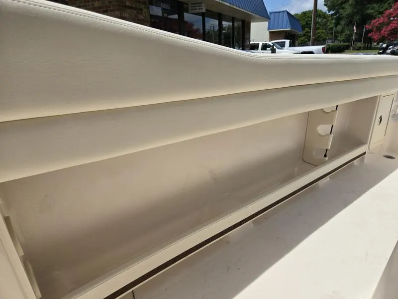 Slide: The Image of 2025 Grady-White Fisherman 236 boat interior storage compartment, beige upholstery. - 19