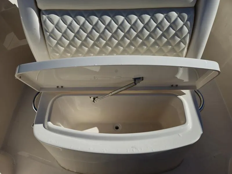 Slide: The Image of Open storage compartment on 2025 Grady-White Fisherman 236 boat with quilted seat back. - 9