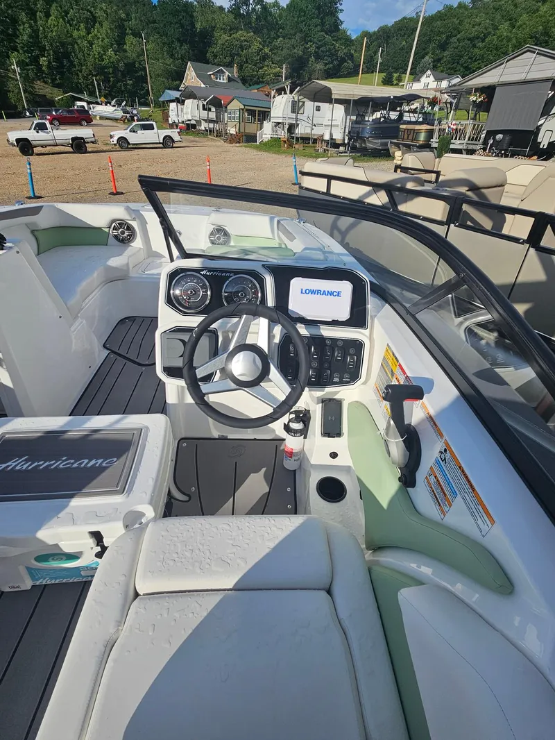 Slide: The Image of Interior of 2025 Hurricane SD2050-OB boat with steering wheel and Lowrance display. - 9