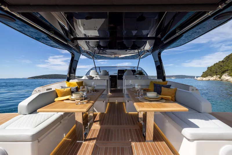 Slide: The Image of Luxurious 2025 Solaris Power 60 Open yacht interior with dining area and ocean view. - 10