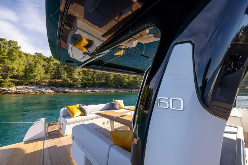 Slide: The Image of 2025 Solaris Power 60 Open luxury yacht with scenic water and forest backdrop. - 17