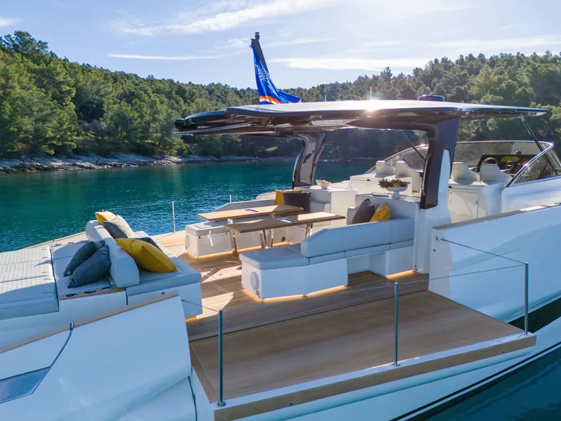 Slide: The Image of Solaris Power 60 Open 2025 yacht with luxurious deck, anchored in a serene bay. - 19