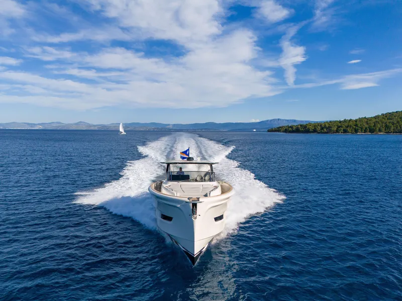 Slide: The Image of 2025 Solaris Power 60 Open yacht cruising on clear blue waters under a sunny sky. - 27