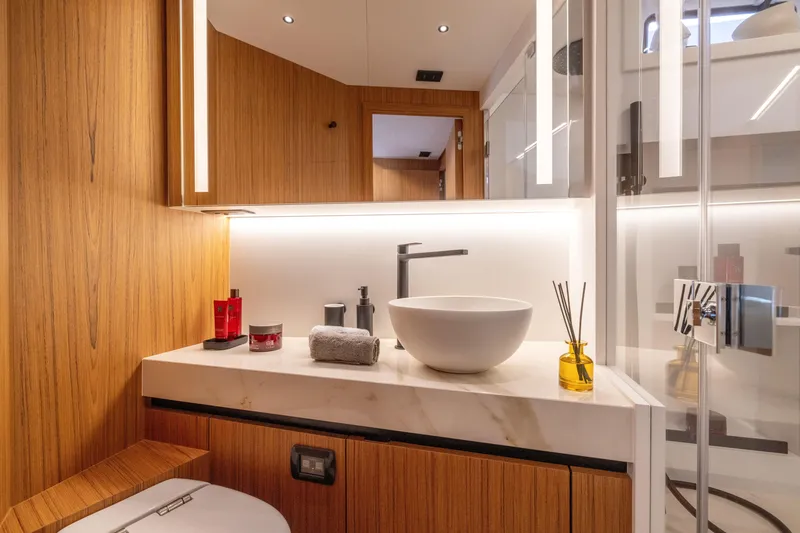 Slide: The Image of Modern bathroom interior of Solaris Power 60 Open 2025 yacht with wooden accents and sleek fixtures. - 39