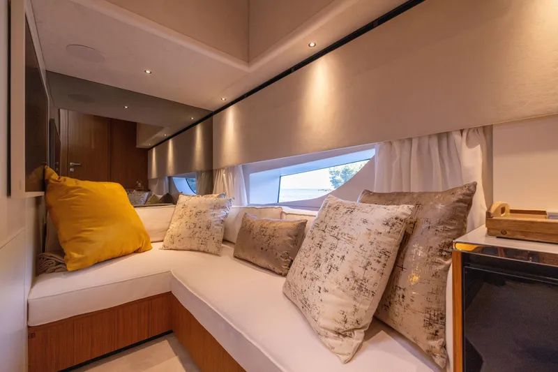 Slide: The Image of Luxurious interior cabin of Solaris Power 60 Open 2025 yacht with plush seating and decorative pillows. - 45
