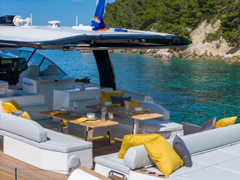 Slide: The Image of Luxurious Solaris Power 60 Open yacht, 2025 model, anchored in a scenic coastal area. - 8