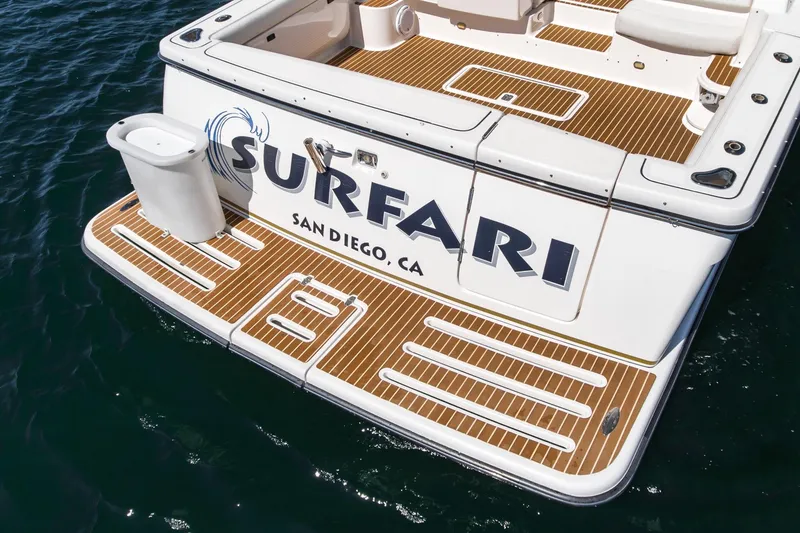 Slide: The Image of Tiara Yachts 3800, 2001 model, docked in San Diego, featuring teak deck and "Surfari" name. - 12