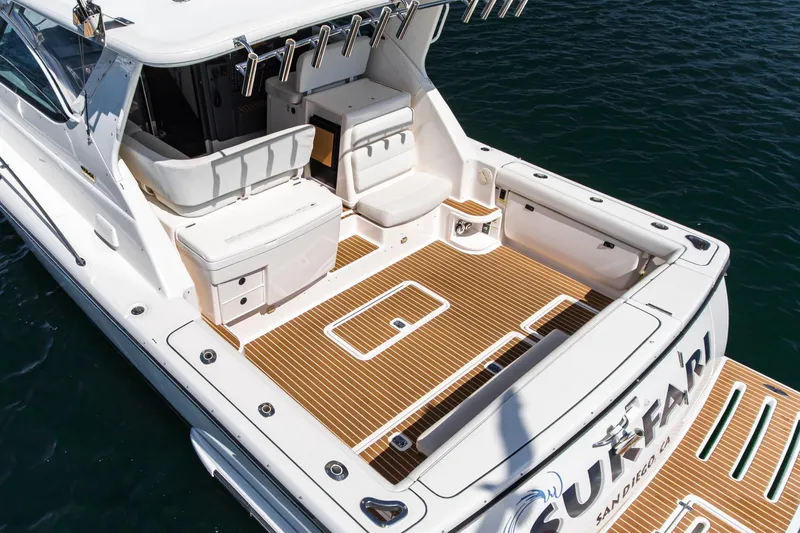 Slide: The Image of 2001 Tiara Yachts 3800 with spacious deck, rod holders, and teak flooring on the water. - 13