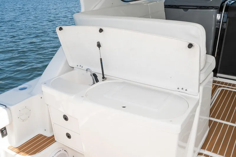 Slide: The Image of Tiara Yachts 3800, 2001 model, featuring a white deck sink and storage area. - 15