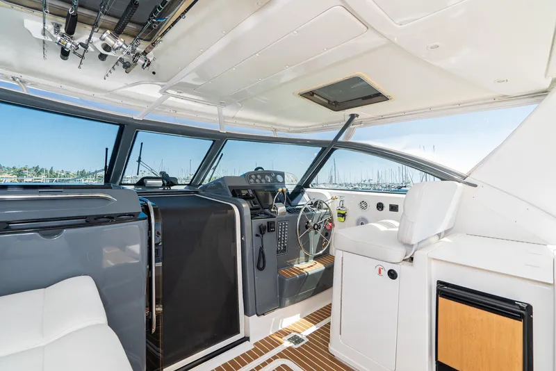 Slide: The Image of 2001 Tiara Yachts 3800 helm with modern controls and panoramic windows. - 22
