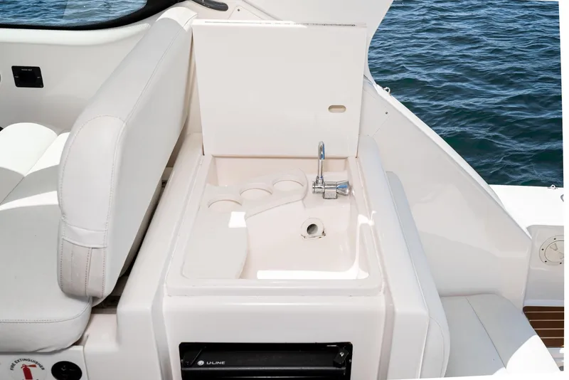 Slide: The Image of 2001 Tiara Yachts 3800 interior with sink and cup holders, overlooking the ocean. - 30