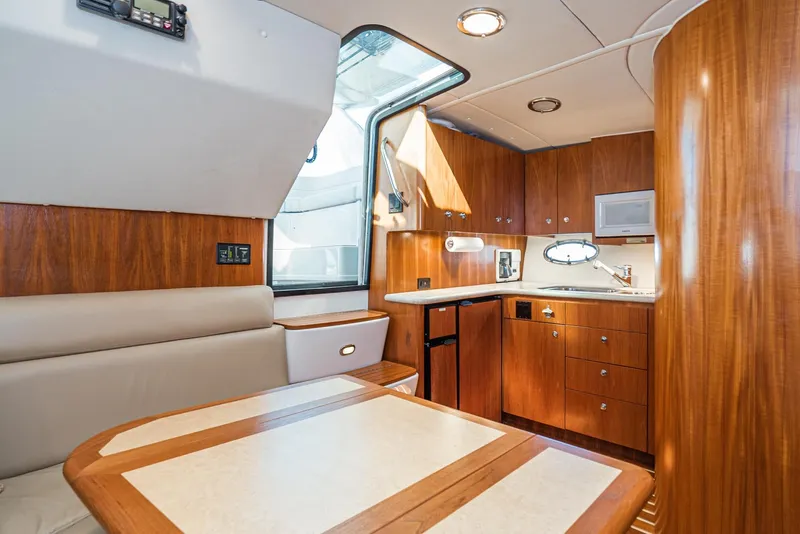 Slide: The Image of 2001 Tiara Yachts 3800 interior with wood cabinetry and dining area. - 33