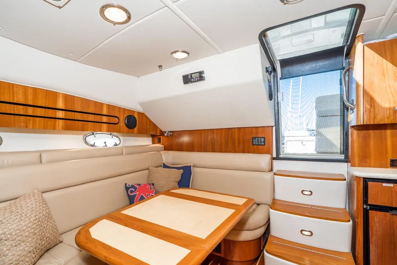 Slide: The Image of Interior of 2001 Tiara Yachts 3800, featuring elegant seating and wooden accents. - 34