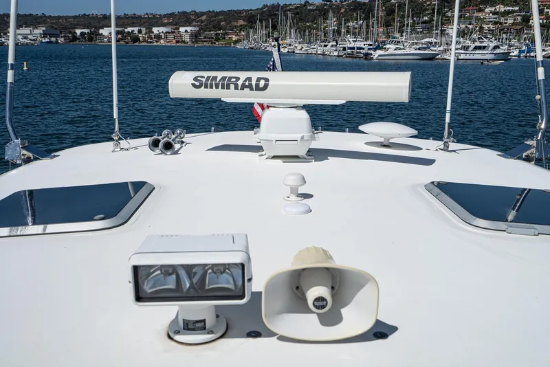 Slide: The Image of Tiara Yachts 3800, 2001 model, featuring Simrad radar, docked in a marina. - 35