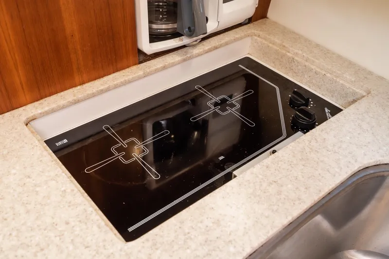 Slide: The Image of Built-in stovetop on 2001 Tiara Yachts 3800, featuring sleek black glass surface. - 37