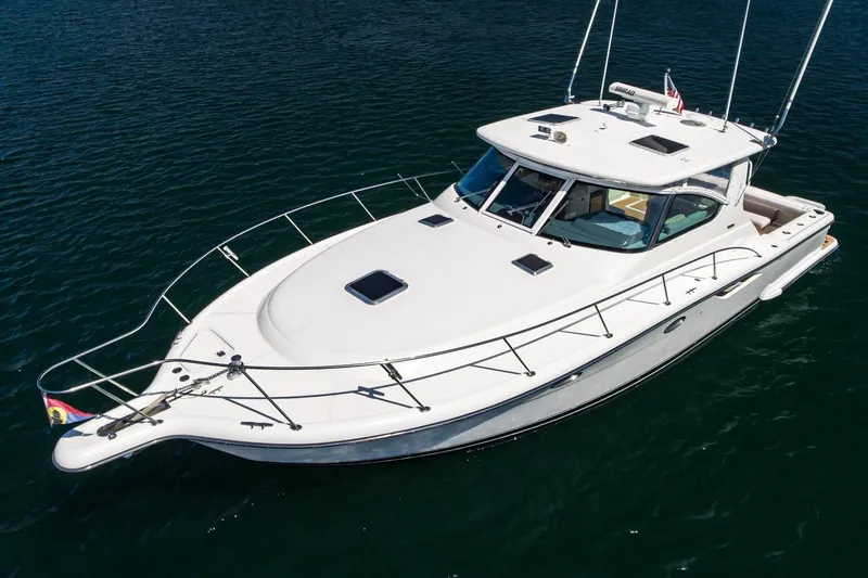 Slide: The Image of 2001 Tiara Yachts 3800, sleek white design, cruising on calm waters. - 4