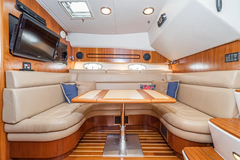 Slide: The Image of Interior of 2001 Tiara Yachts 3800 with plush seating and wooden accents. - 40
