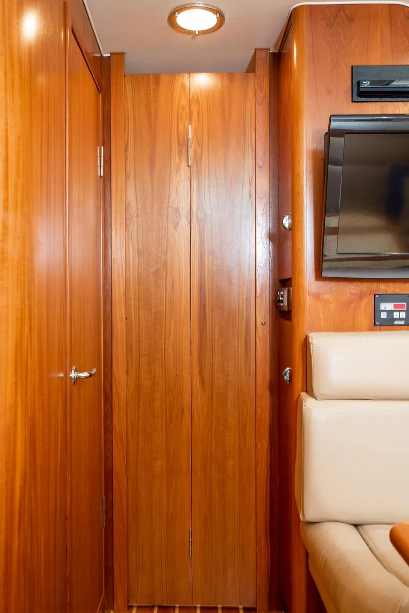 Slide: The Image of Interior of 2001 Tiara Yachts 3800 with wood paneling and seating area. - 43