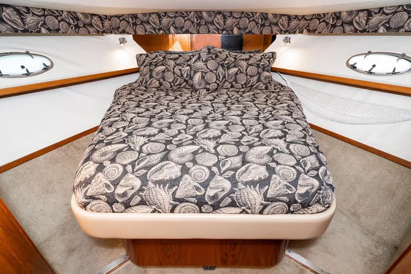 Slide: The Image of Luxurious cabin interior of 2001 Tiara Yachts 3800 with patterned bedding. - 45