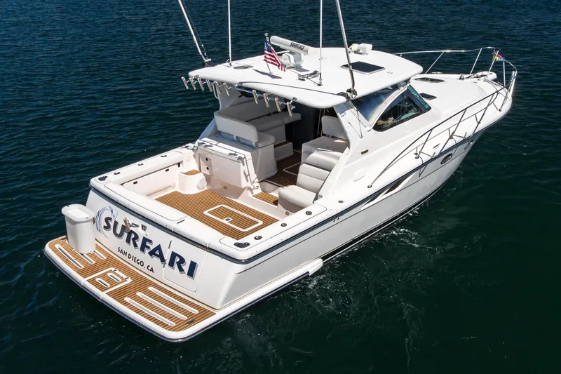 Slide: The Image of 2001 Tiara Yachts 3800 boat on water, rear view, teak deck, white exterior. - 6