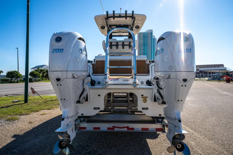 Slide: The Image of 2024 World Cat 260 CC-X boat with dual Yamaha engines, parked outdoors under bright sunlight. - 10